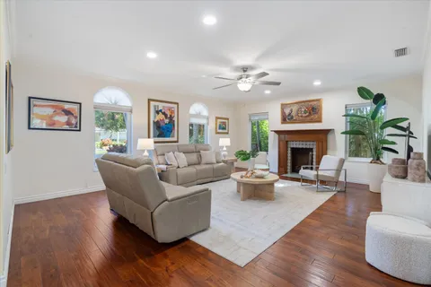 a dining room with furniture wooden floor and a potted plant