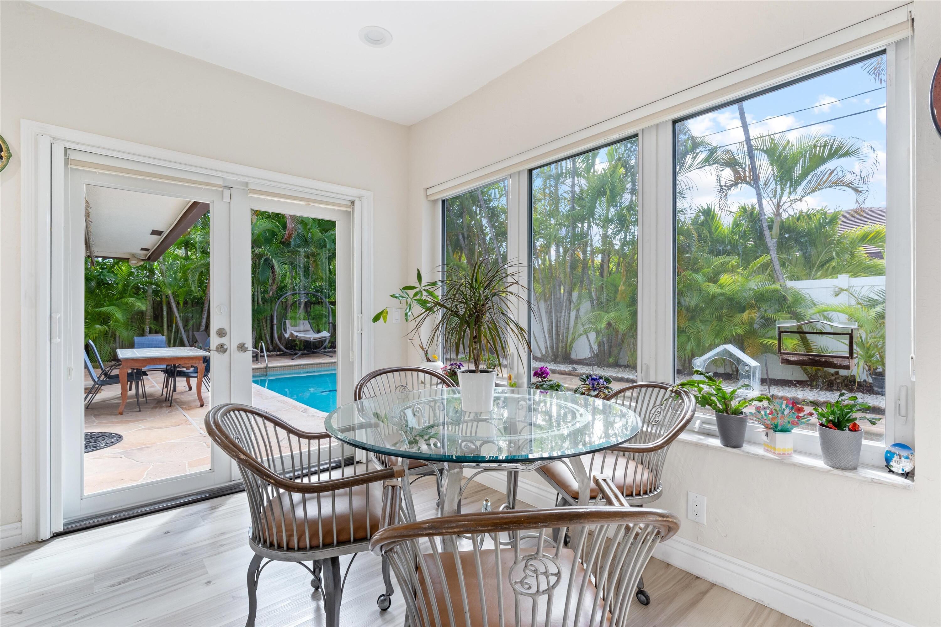 710 Marble Way Boca Raton, FL 33432 - Photo 4 of 57 a dining room with furniture wooden floor and a potted plant