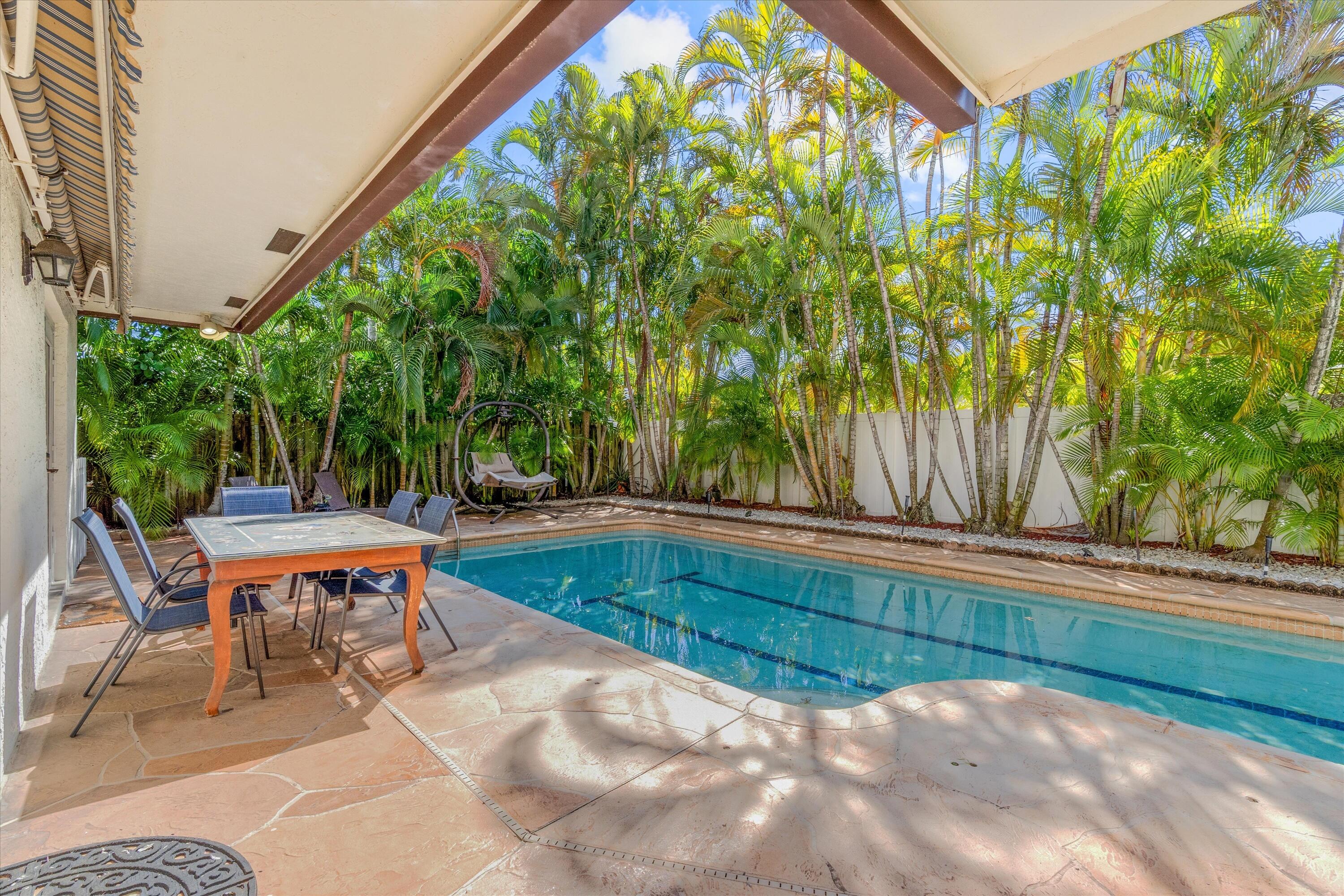 710 Marble Way Boca Raton, FL 33432 - Photo 9 of 57 a view of backyard with swimming pool and outdoor seating