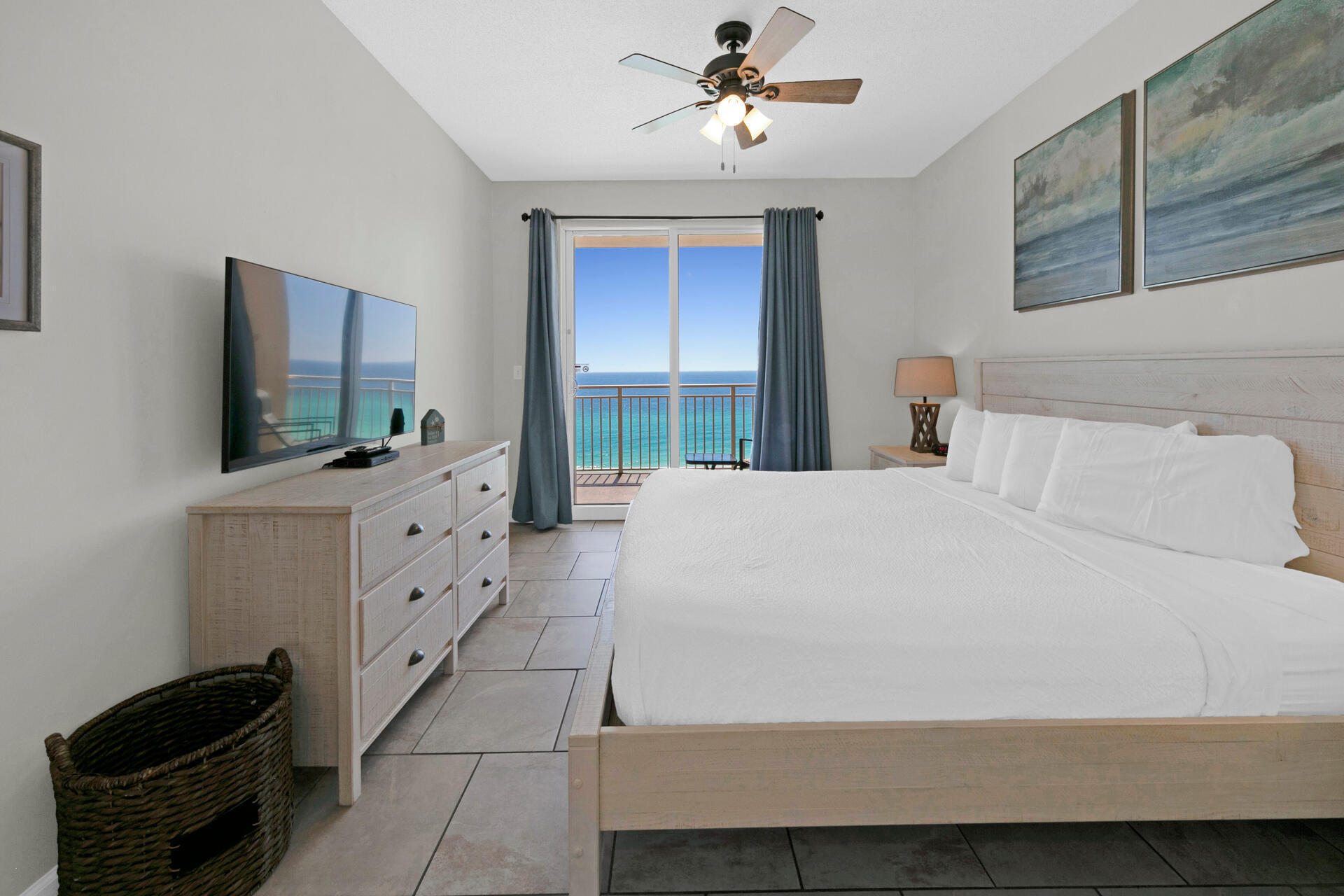 12011 Front Beach Road, Unit 701 Panama City Beach, FL 32407 - Photo 14 of 42 a bedroom with a bed and a flat screen tv