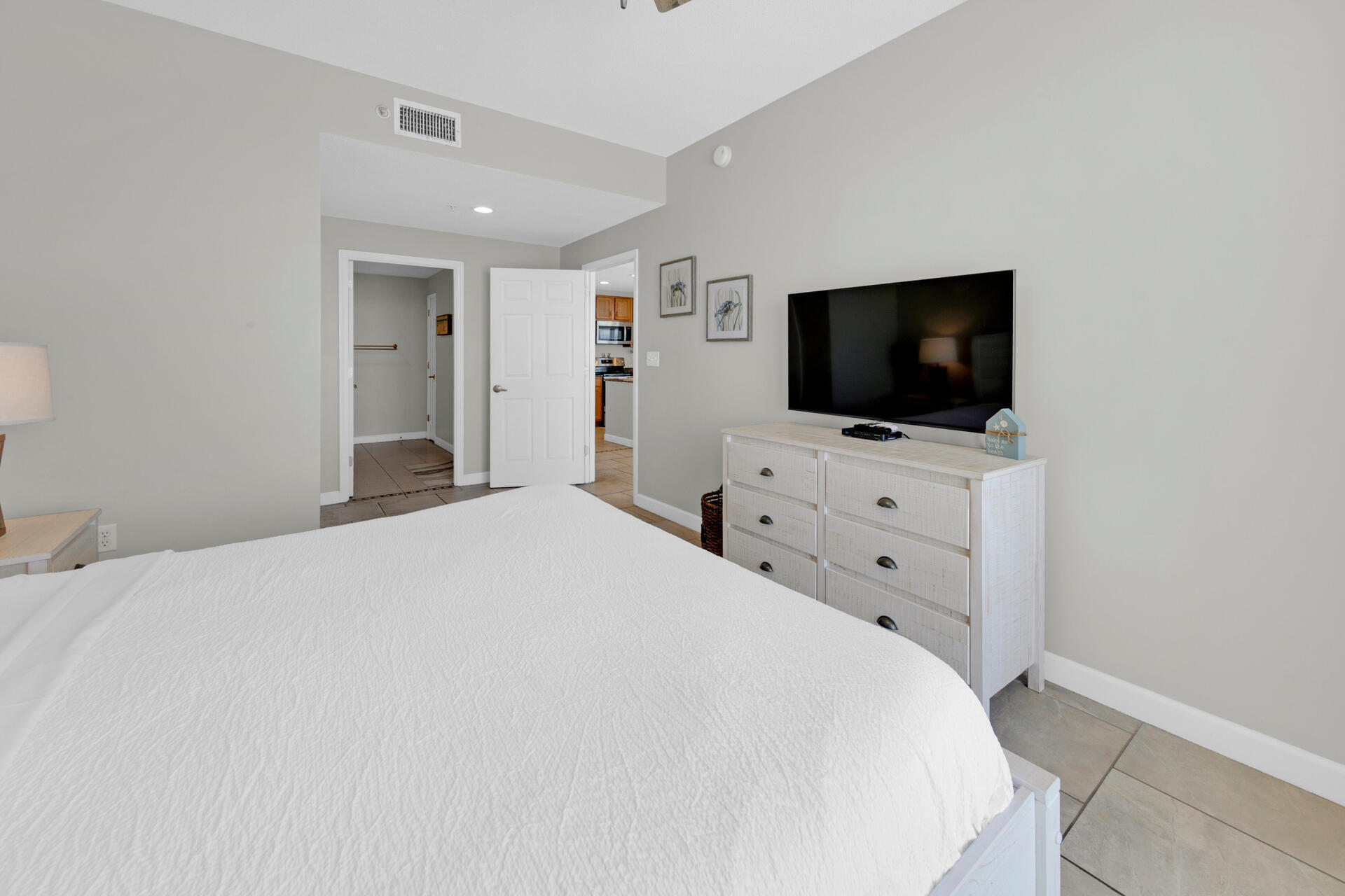 12011 Front Beach Road, Unit 701 Panama City Beach, FL 32407 - Photo 19 of 42 a bedroom with a bed and a flat screen tv