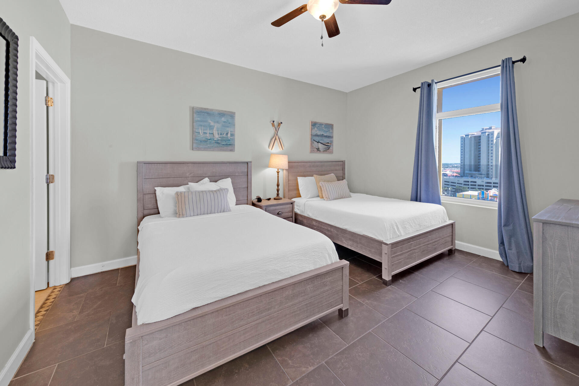 12011 Front Beach Road, Unit 701 Panama City Beach, FL 32407 - Photo 22 of 42 a bedroom with two beds and painting on the wall