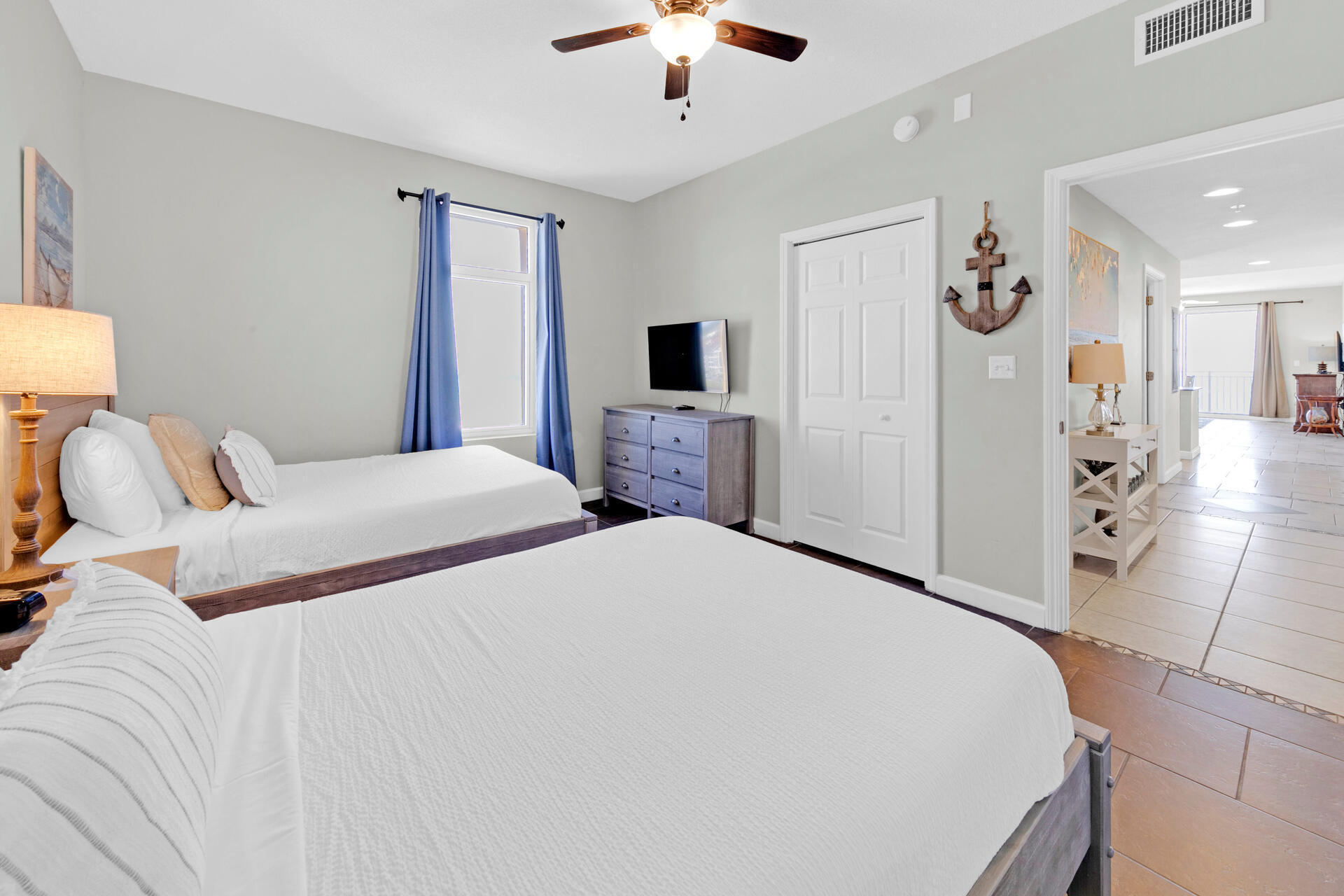 12011 Front Beach Road, Unit 701 Panama City Beach, FL 32407 - Photo 24 of 42 a bedroom with a bed and a chandelier