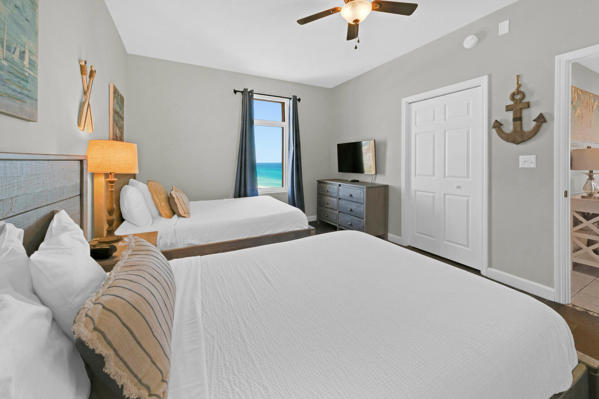12011 Front Beach Road, Unit 701 Panama City Beach, FL 32407 - Photo 25 of 42 a bedroom with bed and a chandelier