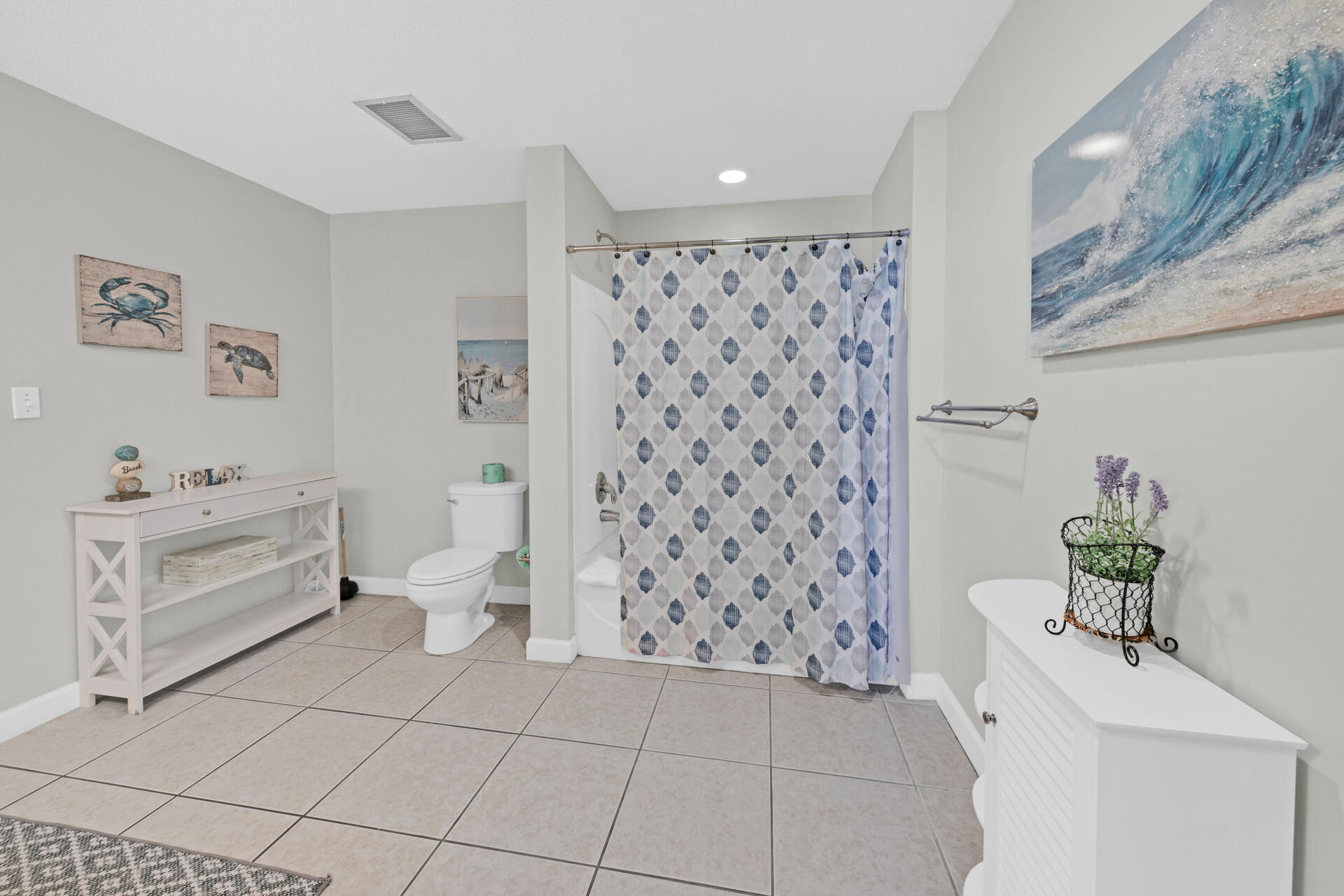 12011 Front Beach Road, Unit 701 Panama City Beach, FL 32407 - Photo 26 of 42 a bathroom with a bathtub sink and toilet