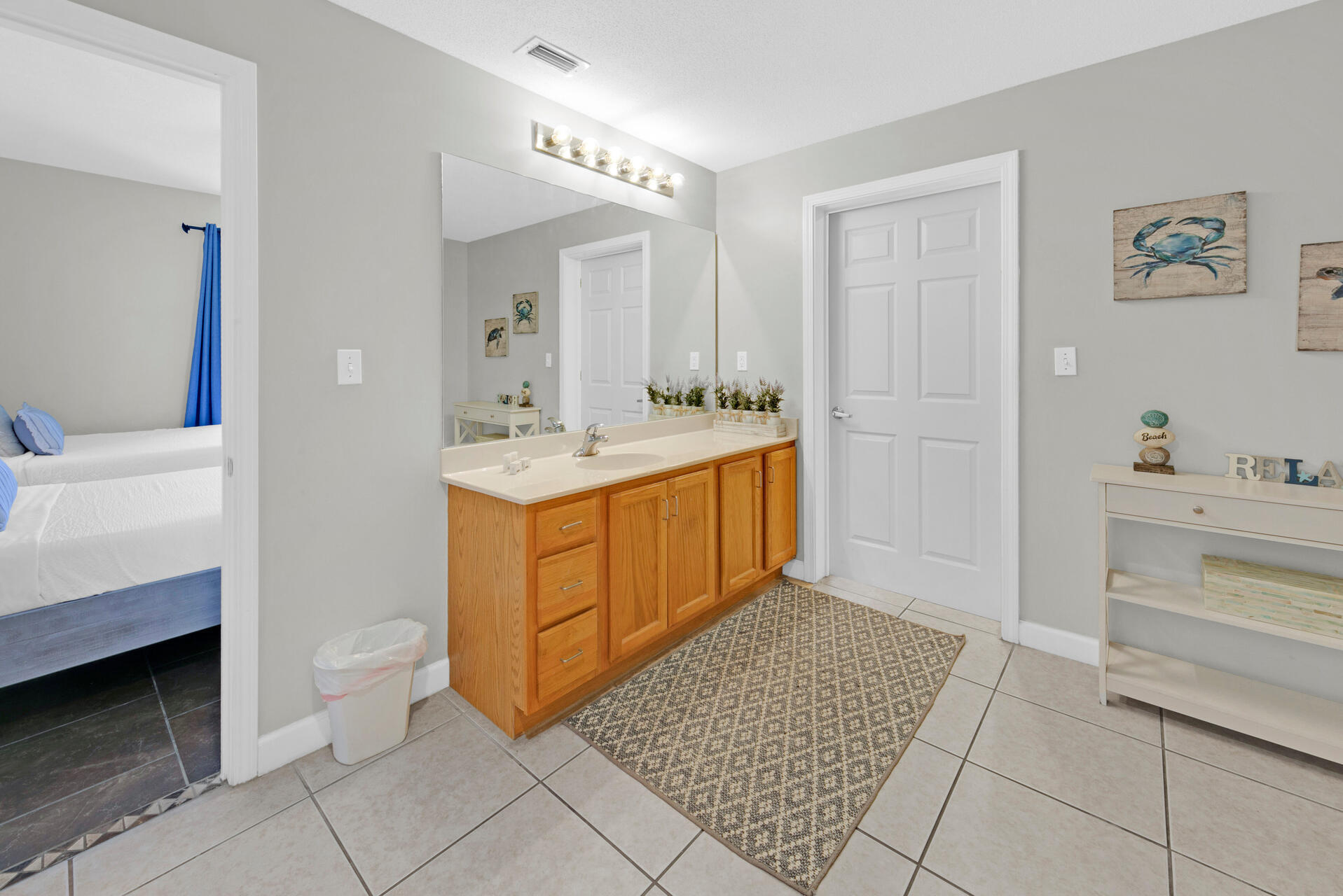 12011 Front Beach Road, Unit 701 Panama City Beach, FL 32407 - Photo 27 of 42 a spacious bathroom with a sink a mirror and a toilet