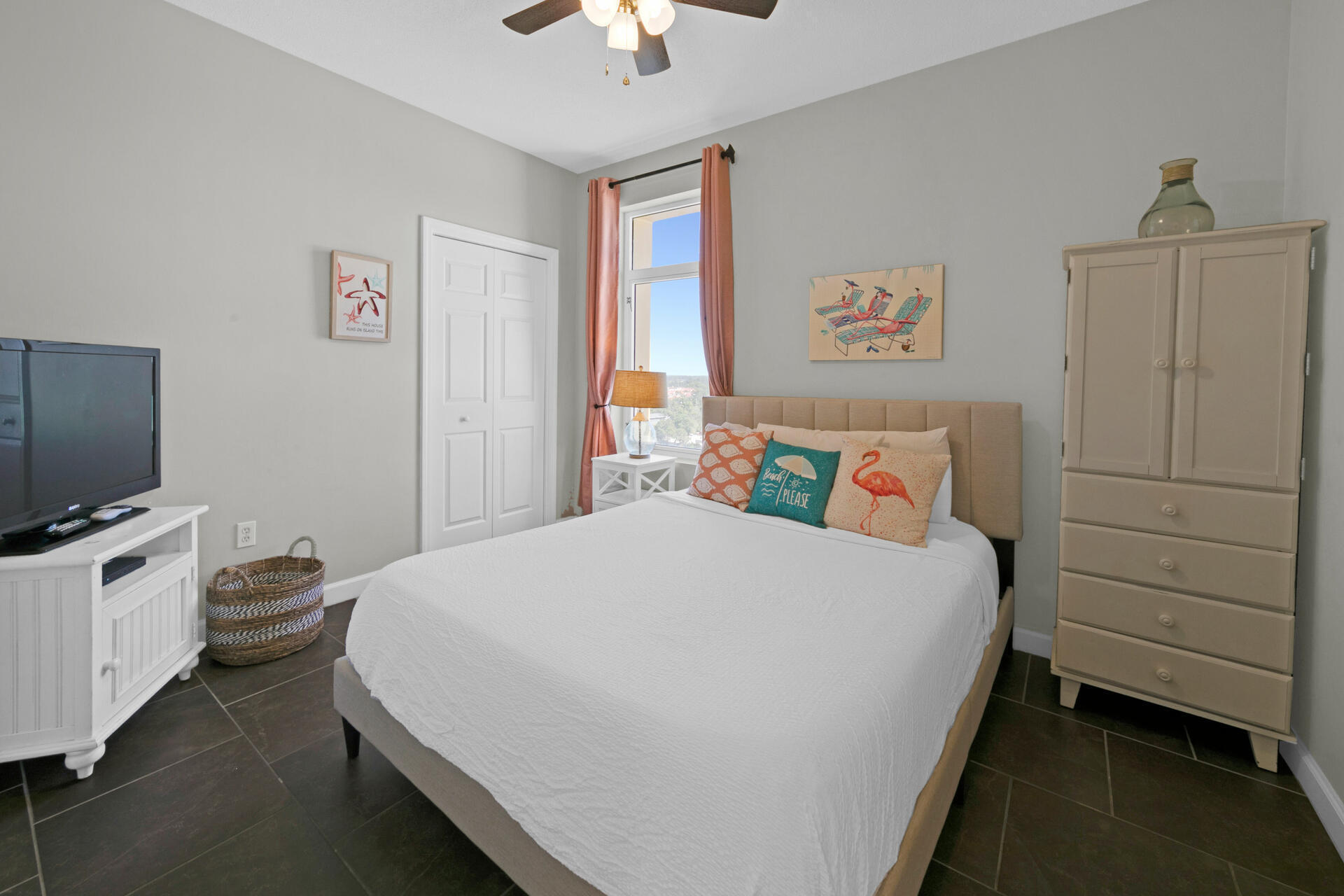 12011 Front Beach Road, Unit 701 Panama City Beach, FL 32407 - Photo 29 of 42 a bedroom with a bed and a flat tv screen on the dresser