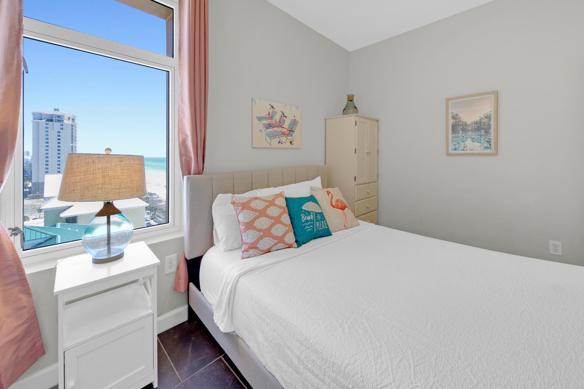12011 Front Beach Road, Unit 701 Panama City Beach, FL 32407 - Photo 31 of 42 a bedroom with a bed and a lamp on table