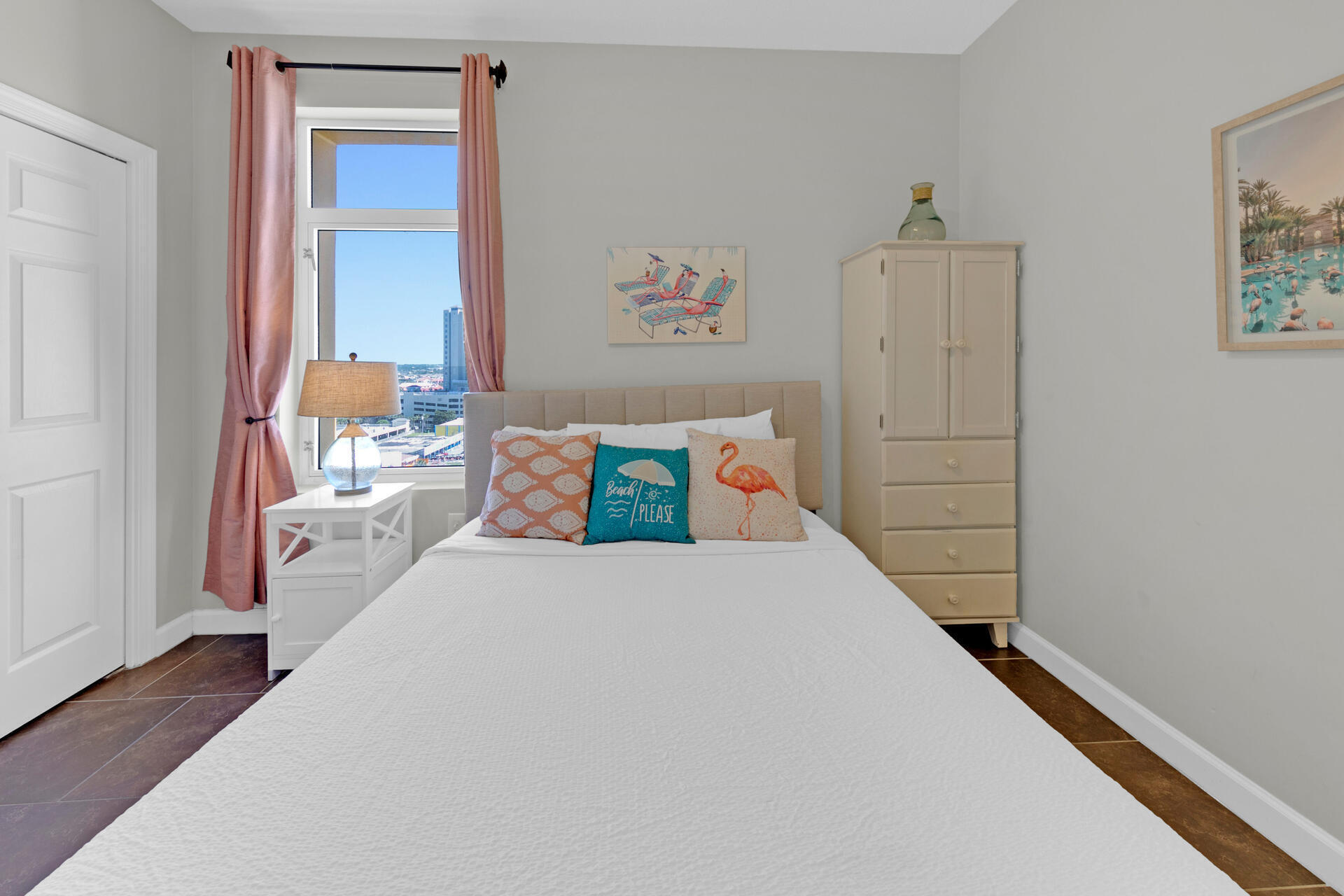 12011 Front Beach Road, Unit 701 Panama City Beach, FL 32407 - Photo 32 of 42 a bedroom with a large bed and a chandelier