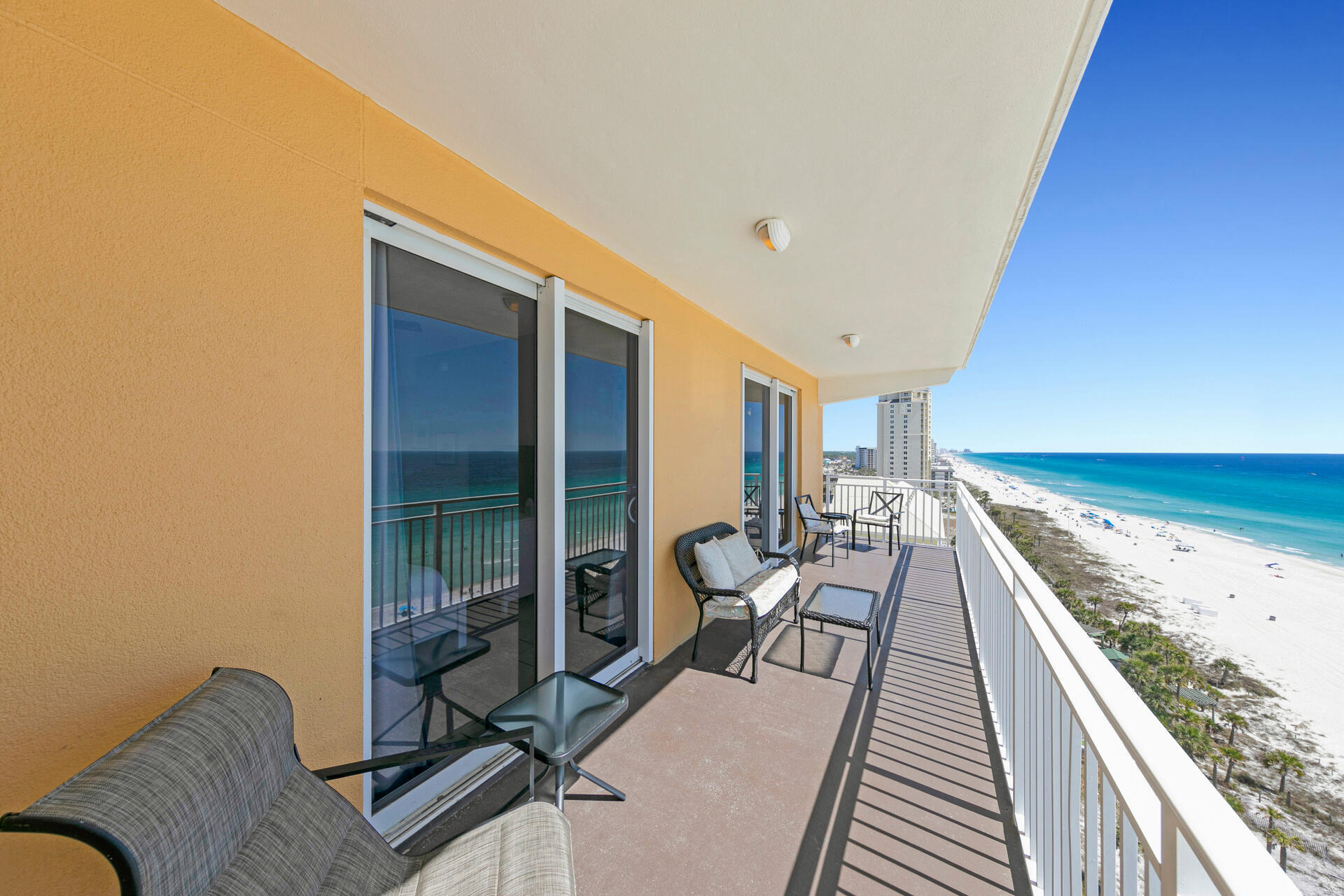 12011 Front Beach Road, Unit 701 Panama City Beach, FL 32407 - Photo 35 of 42 a view of a balcony with chairs and wooden floor