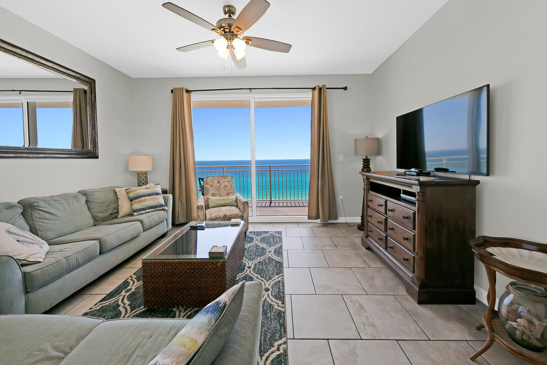 12011 Front Beach Road, Unit 701 Panama City Beach, FL 32407 - Photo 6 of 42 a living room with furniture and a flat screen tv