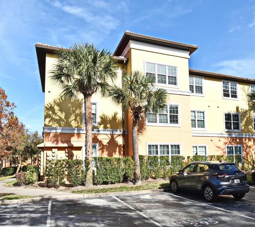 5467 Vineland Road, Unit 6308 Orlando, FL 32811 - Photo 1 of 36 a front view of a residential apartment building with a yard