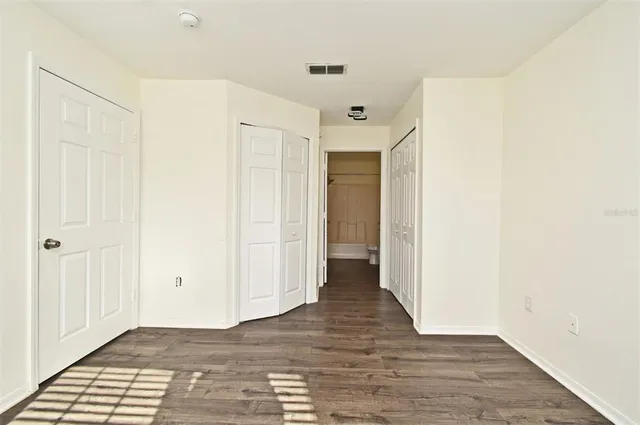 a view of a hallway with wooden floor
