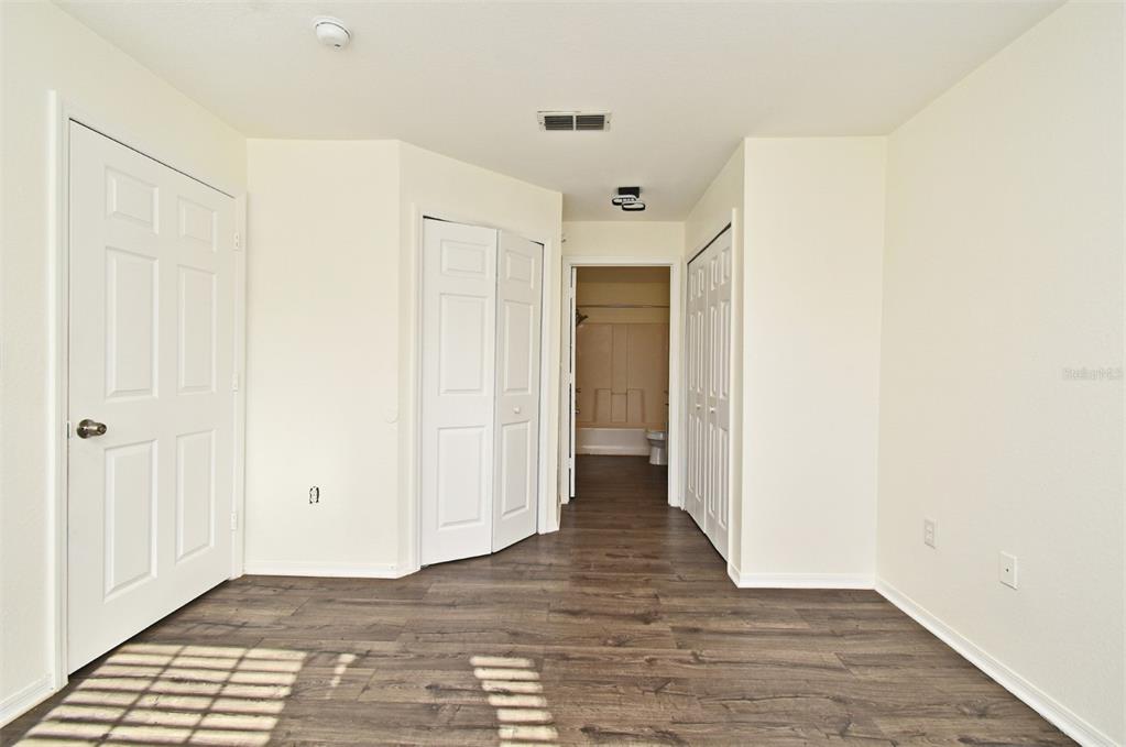 5467 Vineland Road, Unit 6308 Orlando, FL 32811 - Photo 13 of 36 a view of a hallway with wooden floor