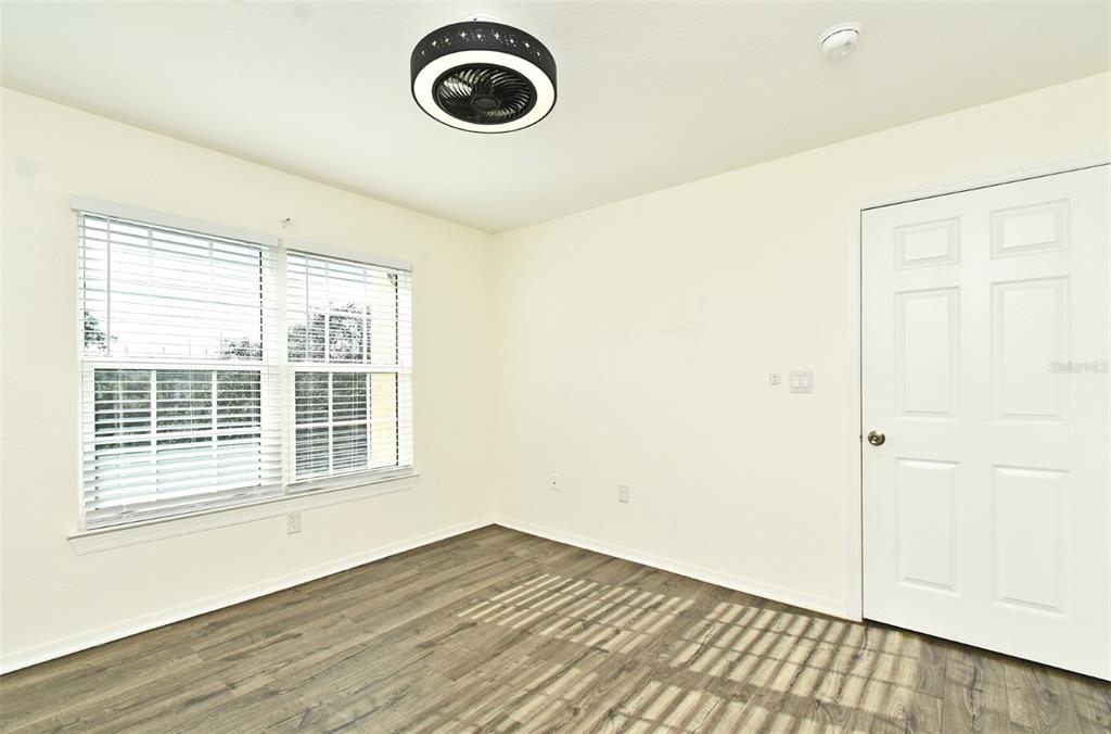 5467 Vineland Road, Unit 6308 Orlando, FL 32811 - Photo 15 of 36 a view of an empty room with wooden floor and a window