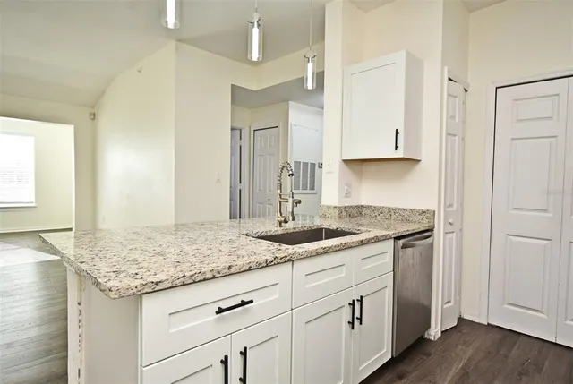 a kitchen with granite countertop granite countertop white cabinets and a granite counter tops