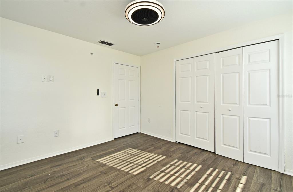 5467 Vineland Road, Unit 6308 Orlando, FL 32811 - Photo 5 of 36 a view of empty room with wooden floor