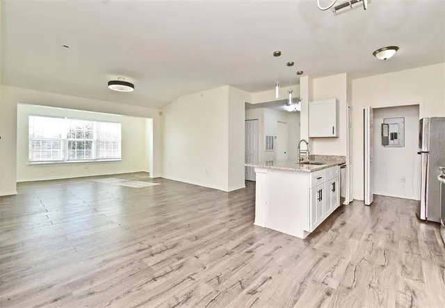 a view of kitchen with wooden floor and window