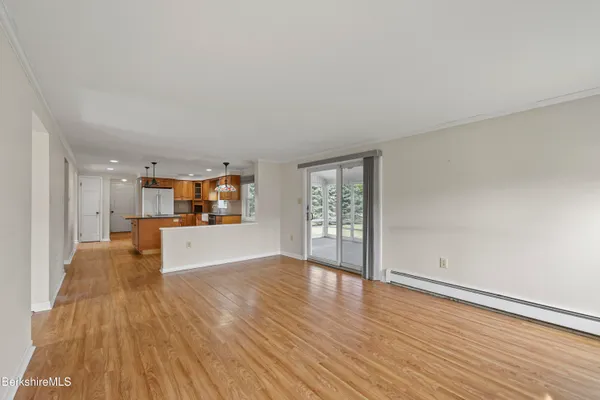 a view of kitchen and hall with wooden floor