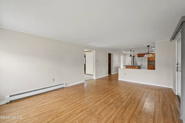 a view of empty room with wooden floor