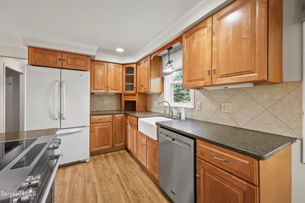 a kitchen with a refrigerator sink and stove