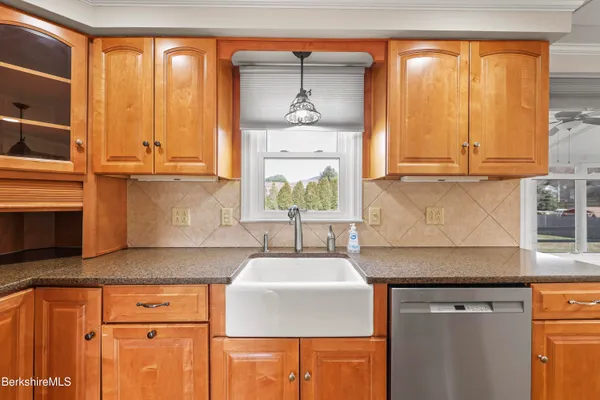 a kitchen with stainless steel appliances granite countertop a sink a stove and a microwave
