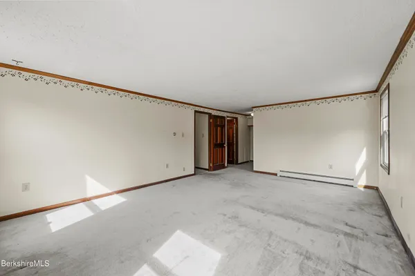 an empty room with windows and closet