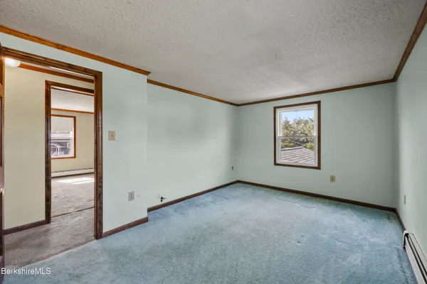 a view of an empty room and closet area