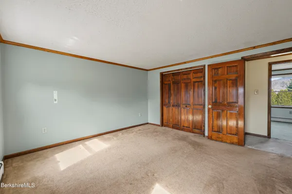 an empty room with closet area