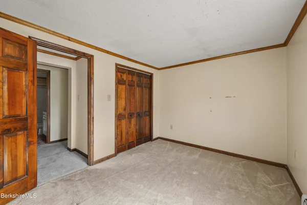 an empty room with closet area