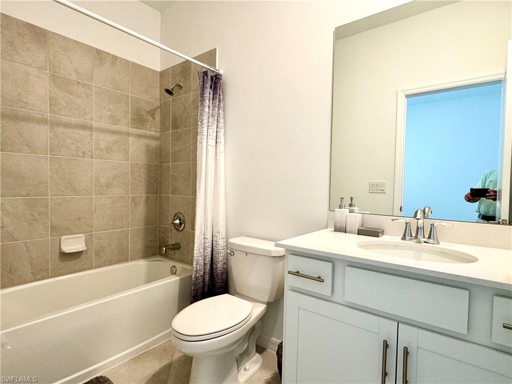 2258 Avocado Lane Naples, FL 34120 - Photo 12 of 18 a bathroom with a sink a toilet and a bathtub