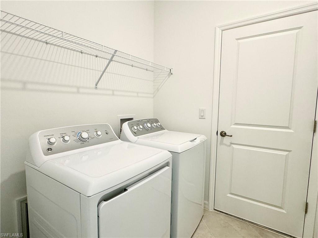 2258 Avocado Lane Naples, FL 34120 - Photo 14 of 18 a utility room with dryer and washer