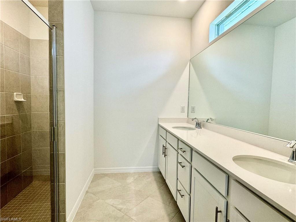 2258 Avocado Lane Naples, FL 34120 - Photo 8 of 18 a bathroom with a sink and a mirror