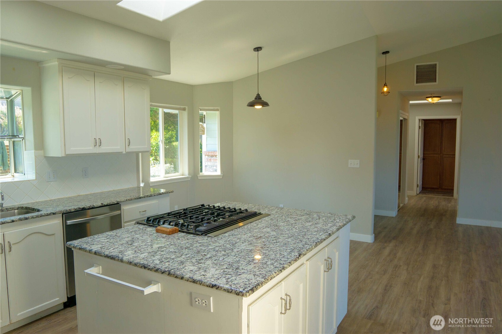 71 Le Roux Road Sequim, WA 98382 - Photo 15 of 40 a kitchen with a granite countertop sink stove and cabinets