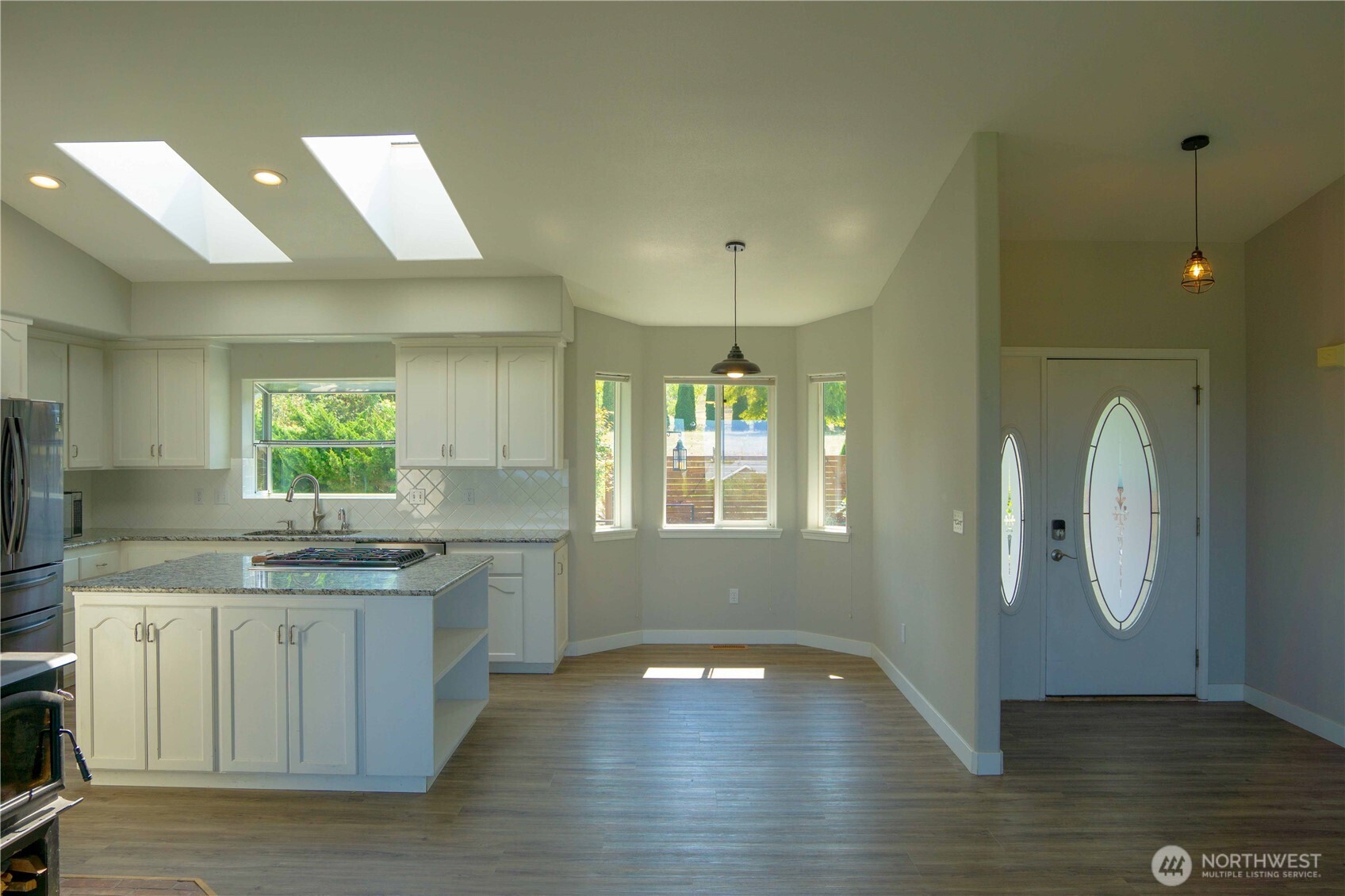 71 Le Roux Road Sequim, WA 98382 - Photo 16 of 40 a kitchen with a sink cabinets and wooden floor