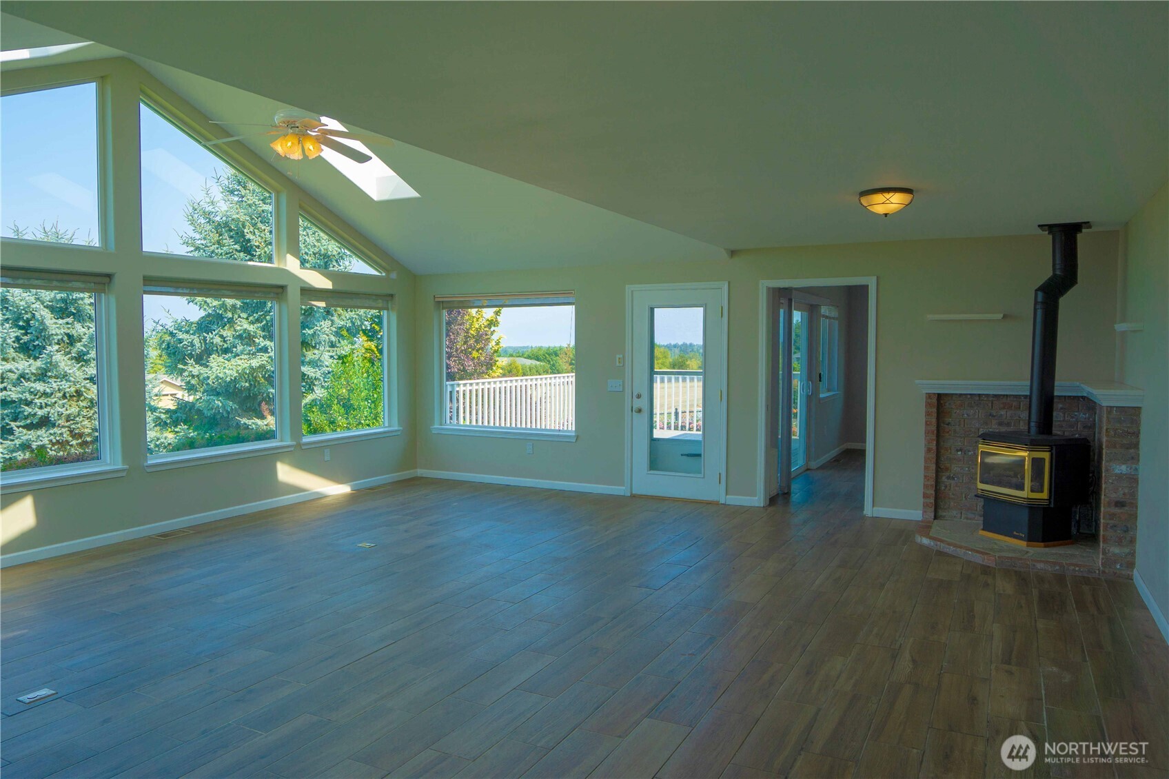 71 Le Roux Road Sequim, WA 98382 - Photo 5 of 40 a view of an empty room with a window and wooden floor