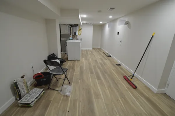 a very nice looking room with wooden floor and furniture