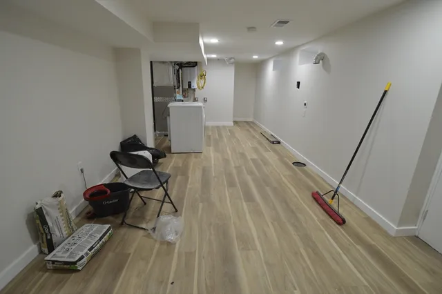 a very nice looking room with wooden floor and furniture