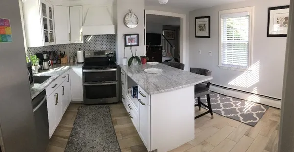 a kitchen with a stove a sink and a refrigerator