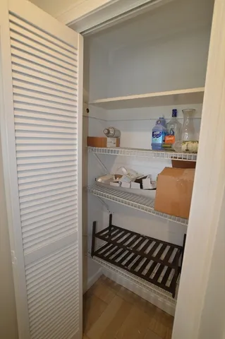 a kitchen with a stove and white cabinet