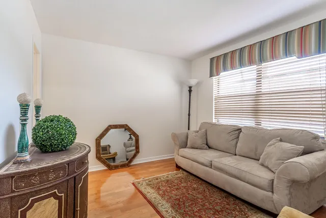 a living room with furniture a couch and a window