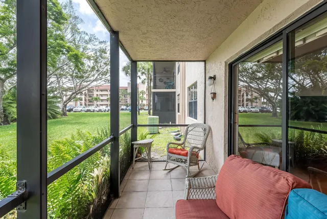 a balcony with furniture and garden view