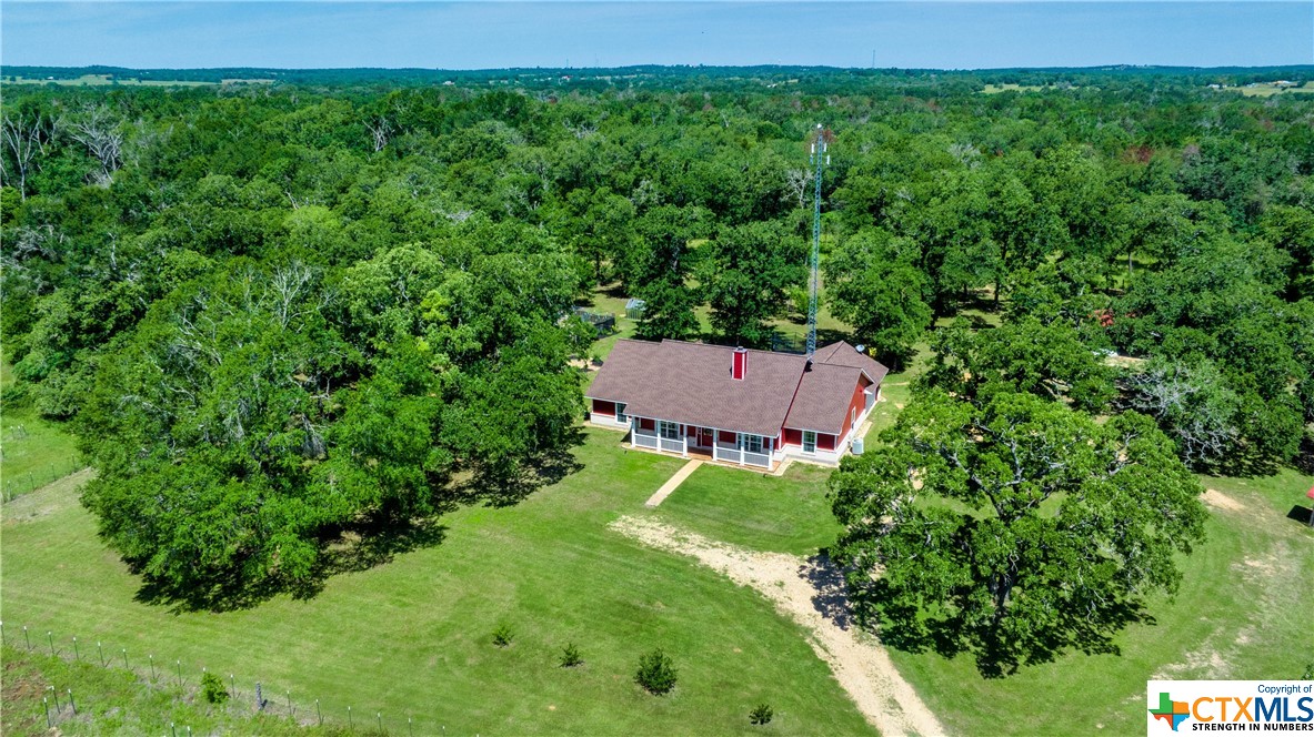 an aerial view of a house with a yard