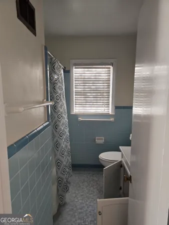 a bathroom with a toilet and shower