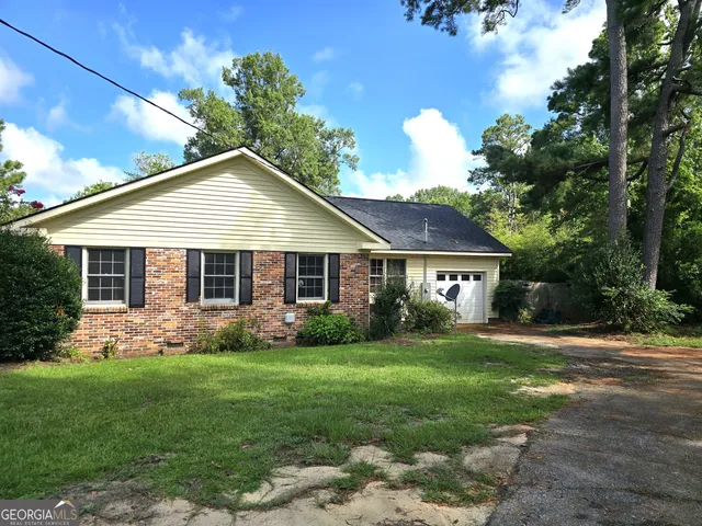 a front view of house with yard and green space
