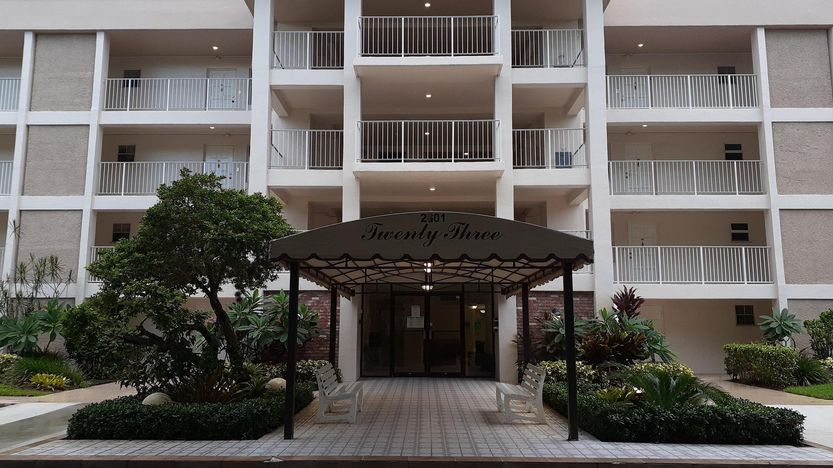 2601 South Course Drive, Unit 203 Pompano Beach, FL 33069 - Photo 1 of 33 a front view of a building with a garden