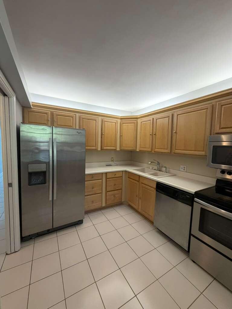 2601 South Course Drive, Unit 203 Pompano Beach, FL 33069 - Photo 13 of 33 a kitchen with stainless steel appliances granite countertop a sink and cabinets