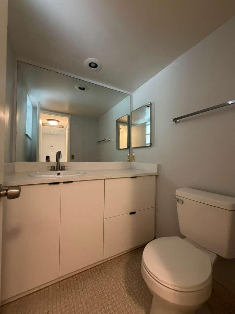 2601 South Course Drive, Unit 203 Pompano Beach, FL 33069 - Photo 16 of 33 a bathroom with a toilet sink and mirror