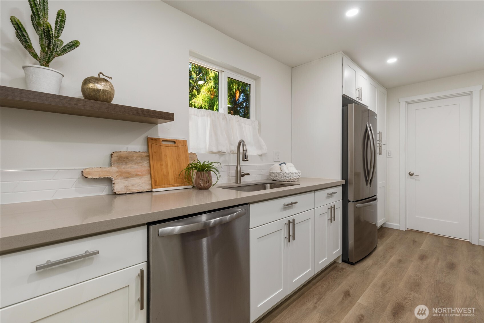 8423 198th Street Southwest Edmonds, WA 98026 - Photo 11 of 26 a kitchen with a sink and a refrigerator