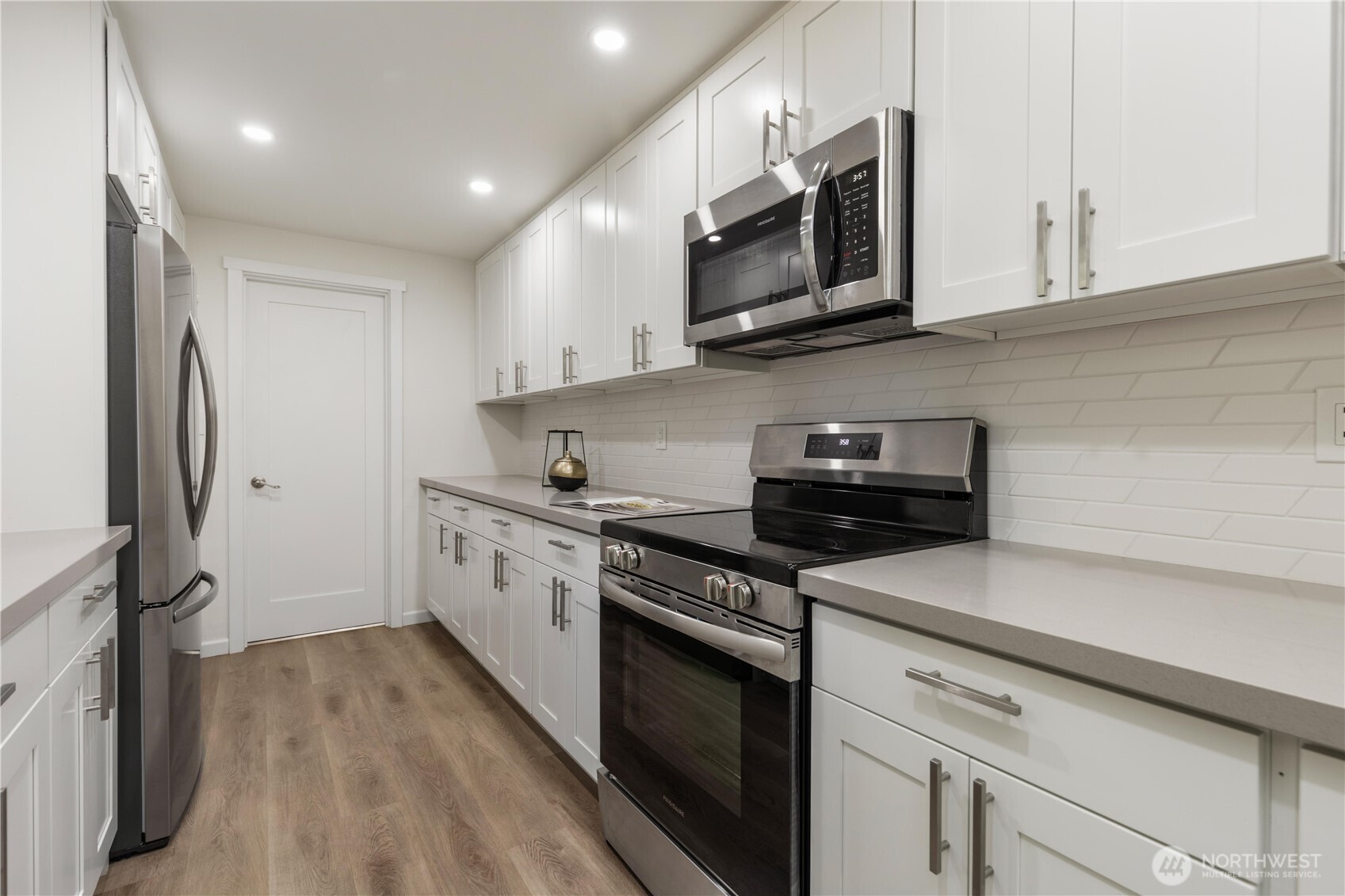 8423 198th Street Southwest Edmonds, WA 98026 - Photo 12 of 26 a kitchen with stainless steel appliances granite countertop a stove a sink and a microwave